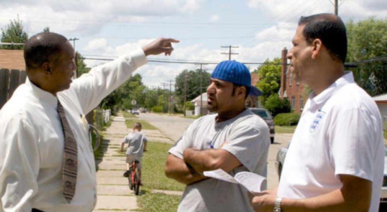 D'Artagnan Collier Speaking to Frank Heleeji and Ali, the family's next-door neighbors.